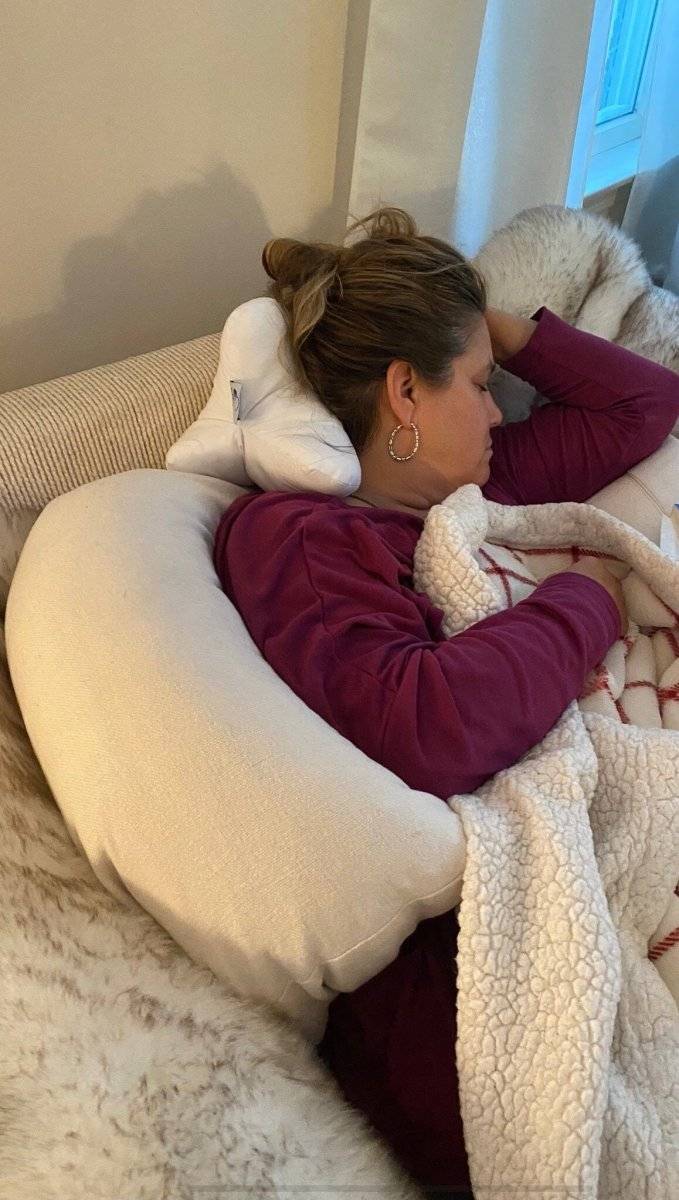 A customer using the neck-o pillow while taking a nap. This cervical pillow is great for getting proper sleeping posture